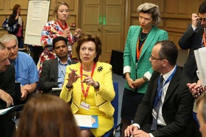 Neelie Kroes in yellow addresses delegates at the Digital Skills for Jobs and Learning Workshop in 2013