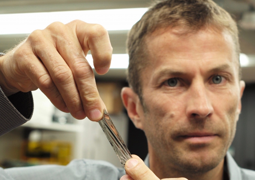 IBM scientist Dr. Mark Lantz, holds a one square inch piece of Sony Storage Media Solutions sputtered tape, which can hold 201 Gigabytes, a new world