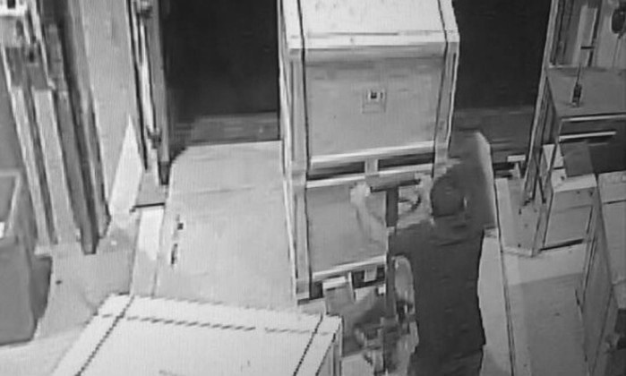 Security footage shows one of the robbers making off with a pallet of Samsung electronics