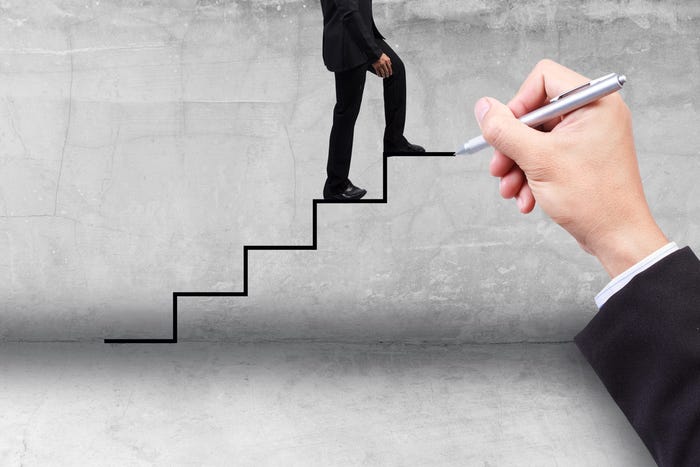 Businessman stepping up ladder