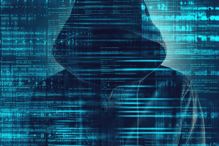 Cloaked hacker behind digital background