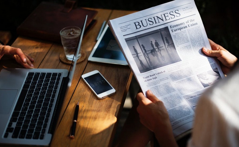 workspace with business newspaper being read