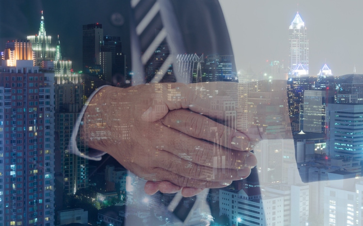 Business handshake with cityscape by Thinkstock