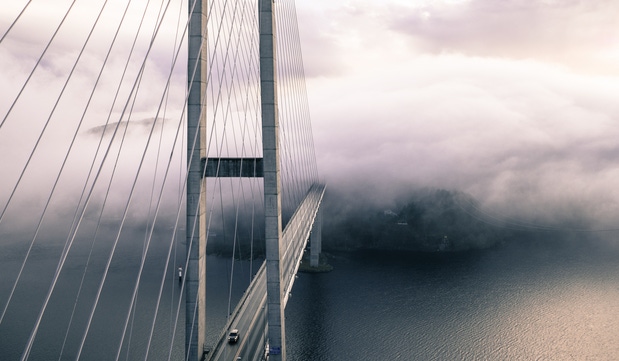Suspension bridge shrouded in clouds