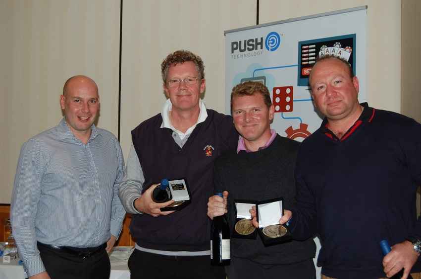 Push Technology CEO Sean Bowen far left poses with the winning team from a company golf tournament in 2012
