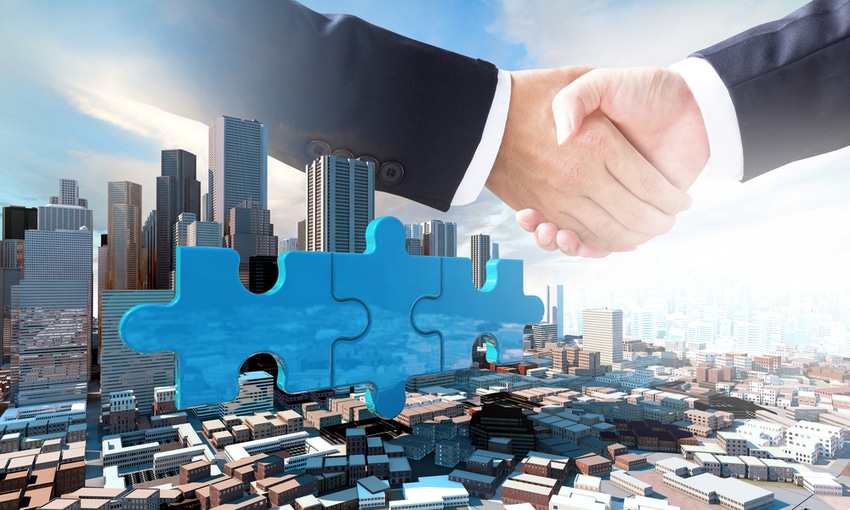 Merger acquisition handshake puzzle pieces over city