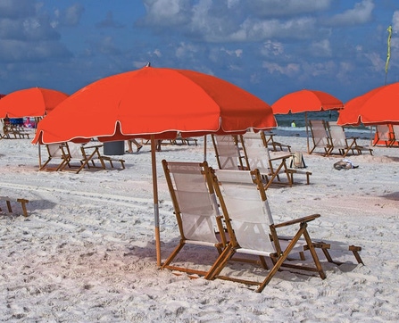 Summer beach scene with red umbrellas