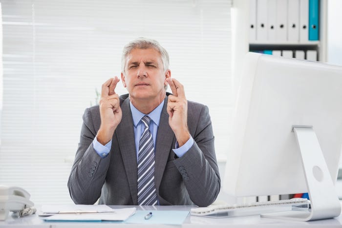 Businessman crossing fingers Businessman crossing fingers