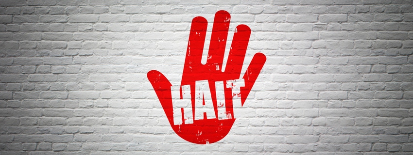 Halt - red hand painted on white wall