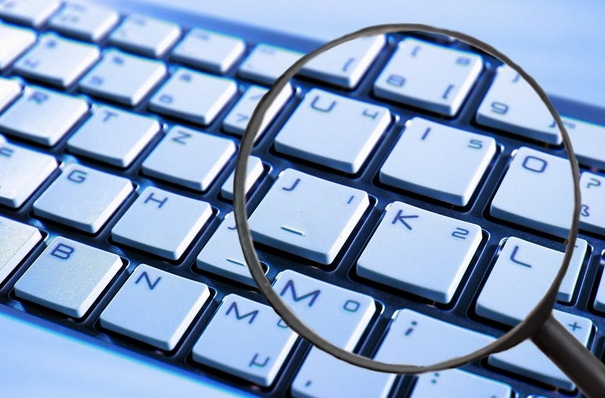 Magnifying glass over close up of keyboard