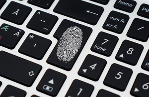 Fingerprint on computer keyboard - security concept