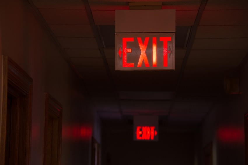 Lit exit signs down hallway