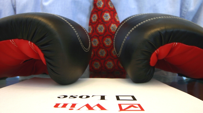 Close-up of a person wearing a tie and boxing gloves with a document in front of them that has Win/Lose checkboxes with a checkmark for "Win"