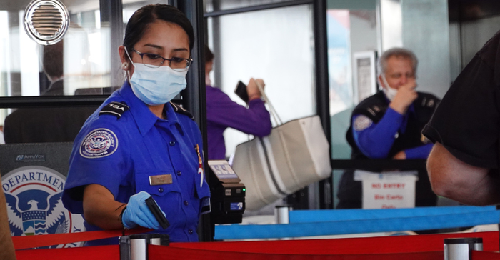 Transportation Security Administration (TSA) workers screen passengers wearing PPE gloves and mask at O'Hare International Airport on November 08, 2021 in Chicago, Illinois. 