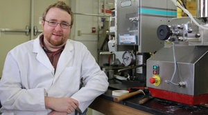 Photo of Alex Jones in a University of Georgia (UGA) lab in 2015. While a doctoral student at UGA, Jones studied antibacterial bioplastics.