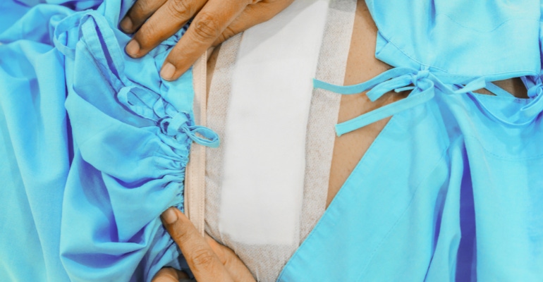 woman with a bandage after laparoscopic hysterectomy.png