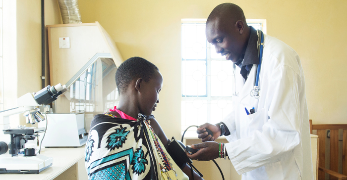 A health worker checks the blood pressure of a young African boy in a busy clinic in Kenya. Africa is seeing impressive levels of growth in medtech innovation and investment.