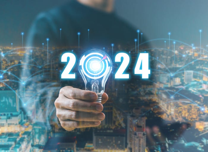 Image of a business person holding a lightbulb in place of the "0" in "2024" illustrates tech and innovation concept