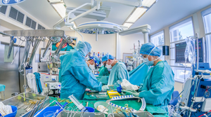 Operating room staff surrounded by medical devices, medtech