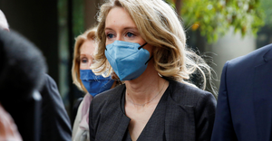 Theranos founder Elizabeth Holmes (center) arrives to attend her fraud trial at federal court in San Jose, California, U.S.