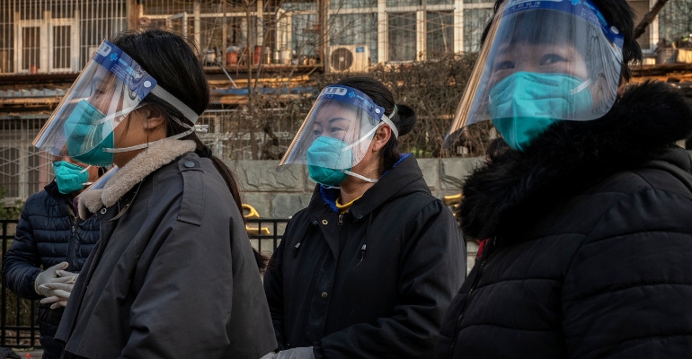 Women wear masks and face shields in an area that was recently locked down due to COVID-19 cases but now reopened, on