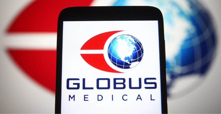 In this image, the Globus Medical is shown on a smartphone screen with a larger version of the logo in the background out of