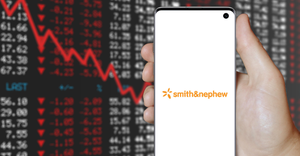 picture of a smart phone showing the Smith & Nephew logo, with a negative stock market screen in the background.