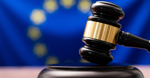 Gavel with flag of the European Union in the background.png