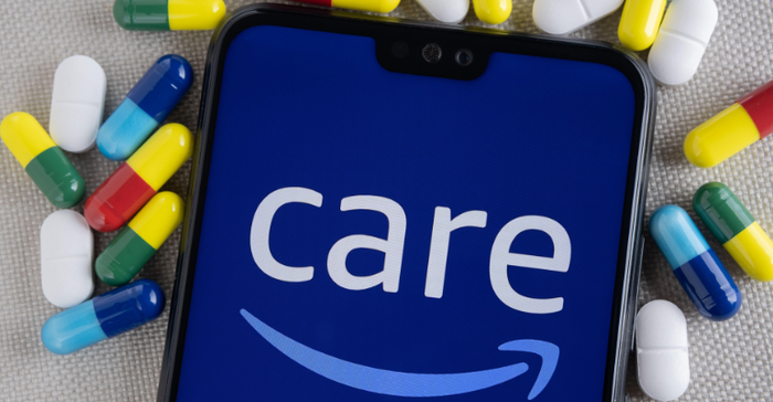 Amazon Care logo seen on a smartphone screen with an assortment of pills around it.