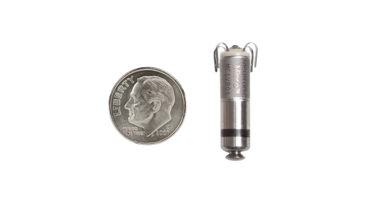 The Medtronic Micra leadless pacemaker, shown beside a U.S. dime for size comparison.