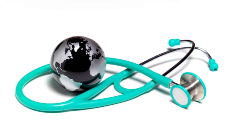 global medical concept showing a stethoscope and miniature globe together.