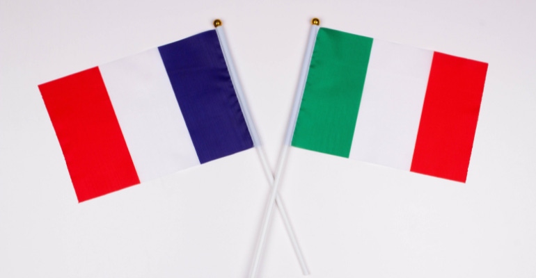 flag of France and flag of Italy crossed with plain white background.