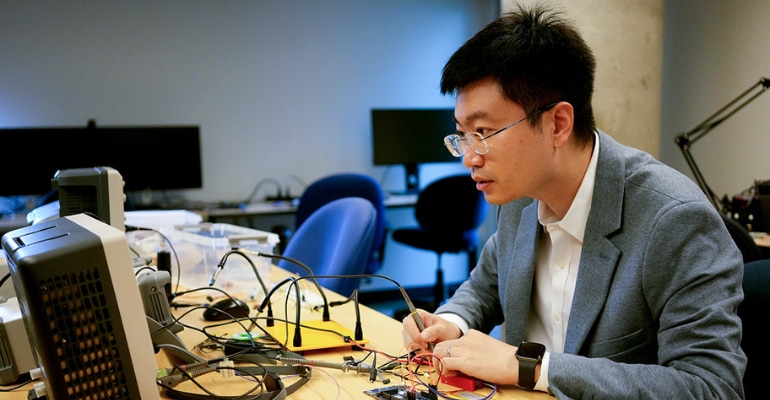 Xilin Liu, a researcher at the University of Toronto, tests signal integrity of a prototype neural implant, which can be