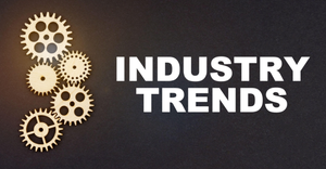 Business and industry concept. On a black background, gears and the inscription - INDUSTRY TRENDS
