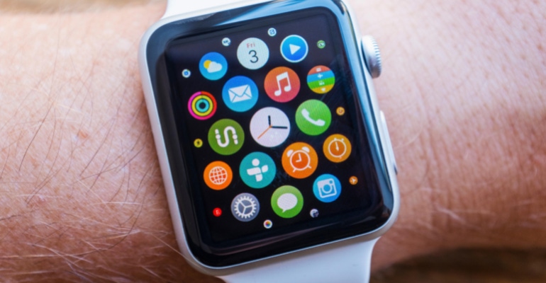 Apple Watch on a person's wrist showing many different app icons.png