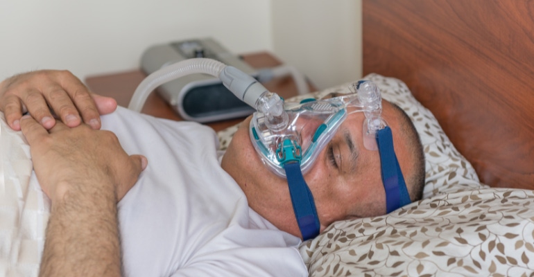 Man wearing a CPAP mask for sleep apnea