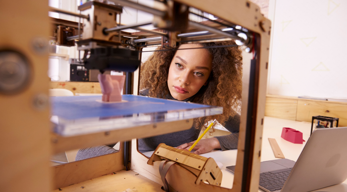 product design engineer using 3D printer to prepare a 3D representation of her design