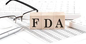FDA letters on blocks next to glasses