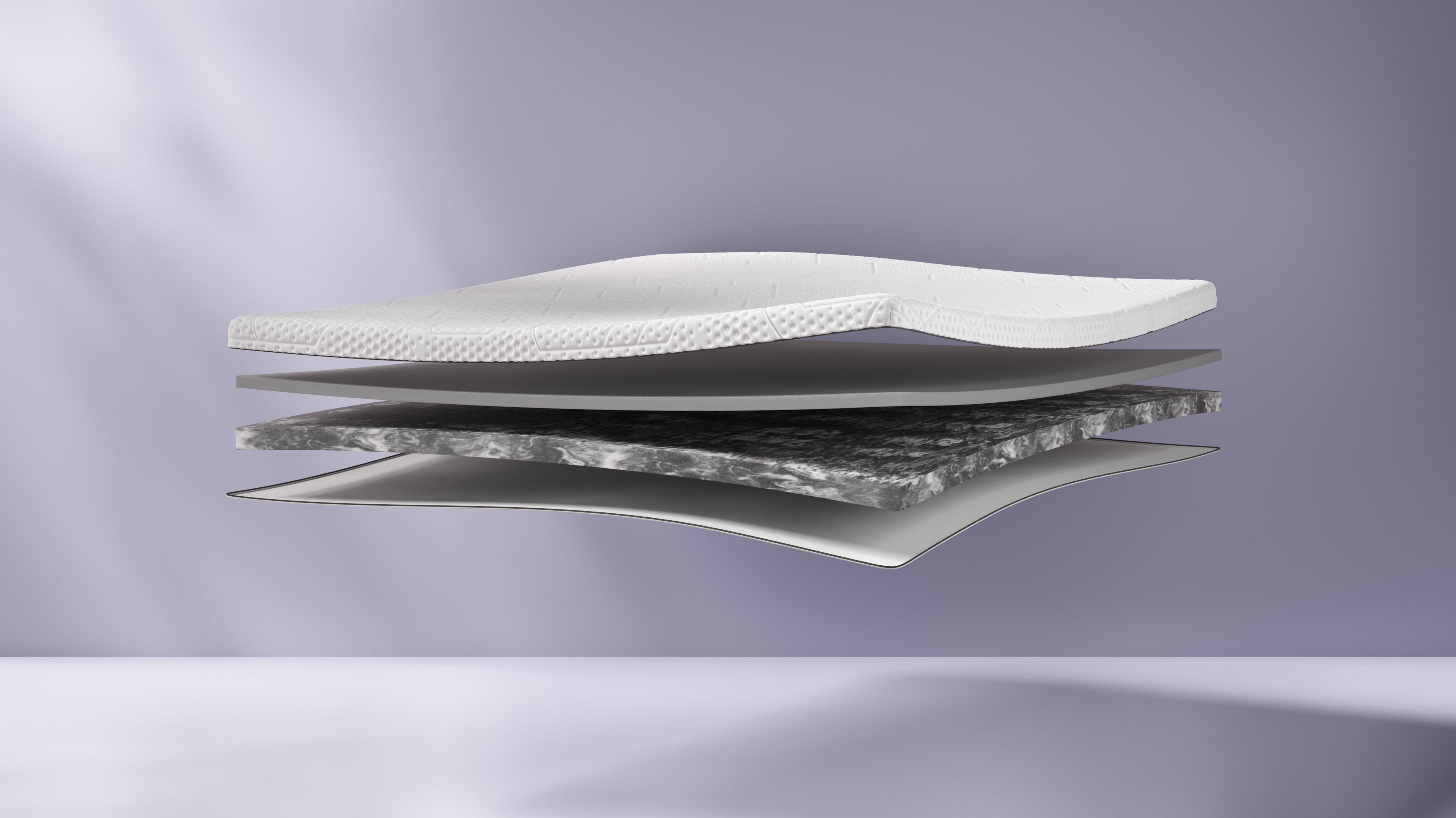 The Emma Premium Mattress Topper cut on the side and showing the expanded layers.