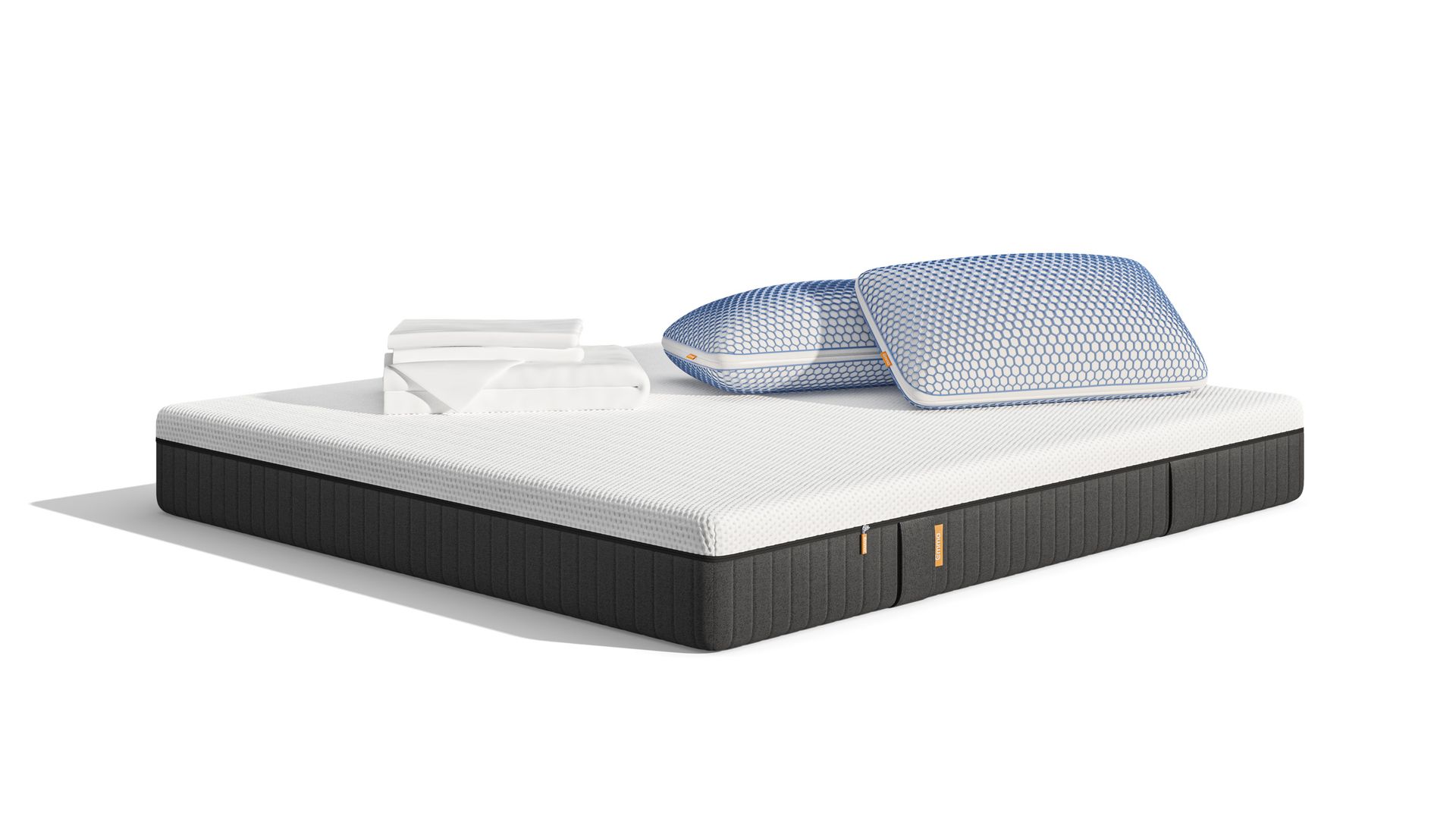 Uma imagem do Pack Cooling Pro+ Plus, que inclui um colchão Emma Original Pro+, Almofadas Emma Original Microfibra Elite, uma capa protetora, e roupa de cama