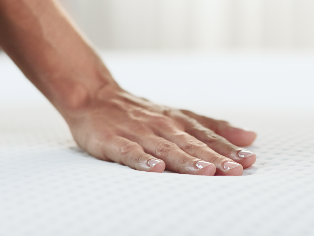 Hand pressing on a Medium-Hard Mattress