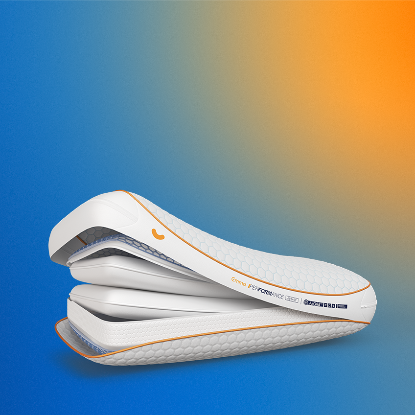 Emma Performance Hybrid Pillow cross-section showing hexagonal cover with orange trim, AirGrid layer, and foam layers.