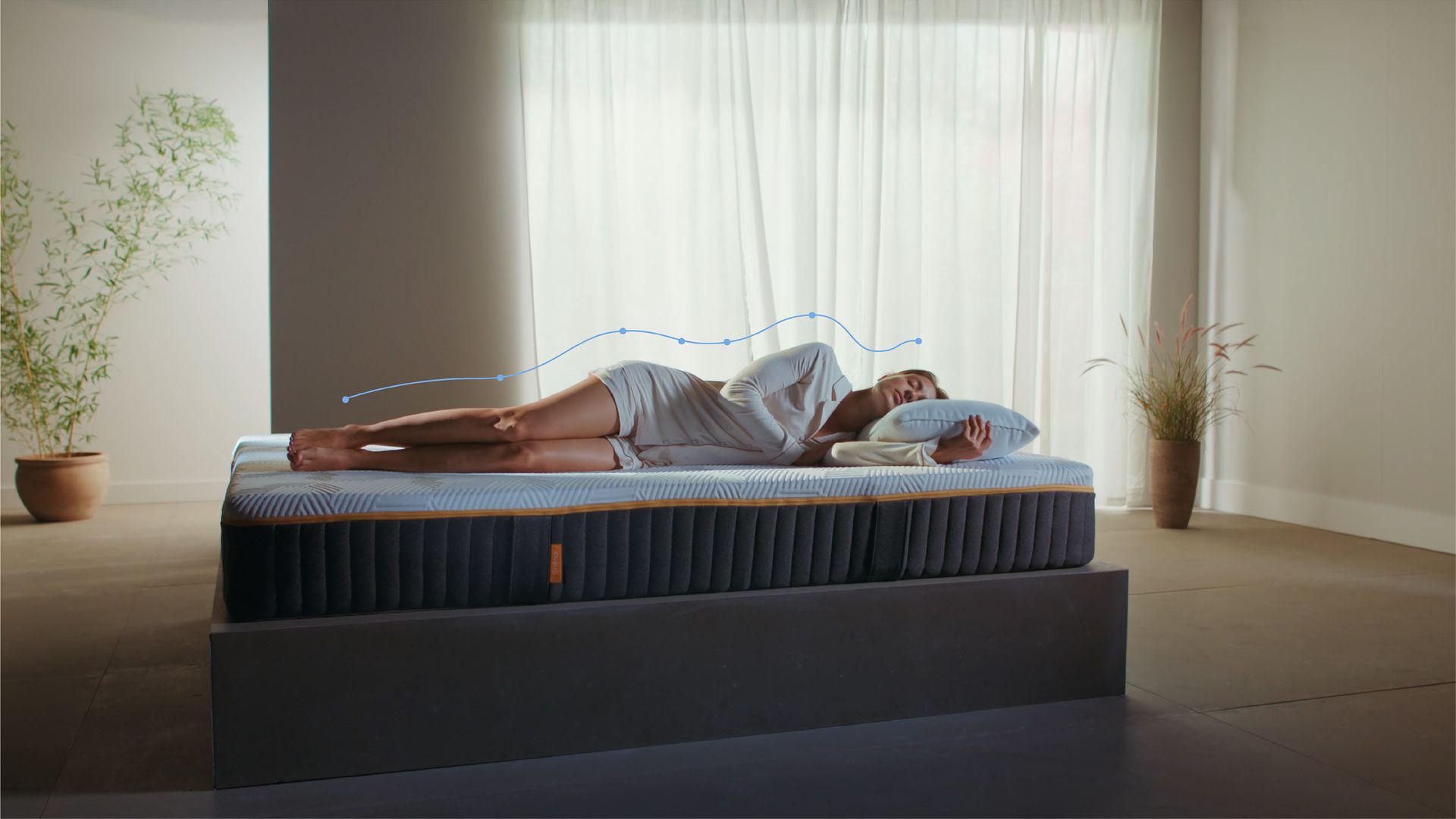 A woman laying on top of an Emma Original Elite Mattress with a figurative line showing body support and alignment.