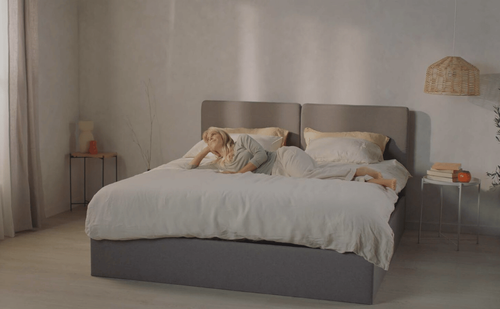 Happy woman laying on top of Emma Mattress