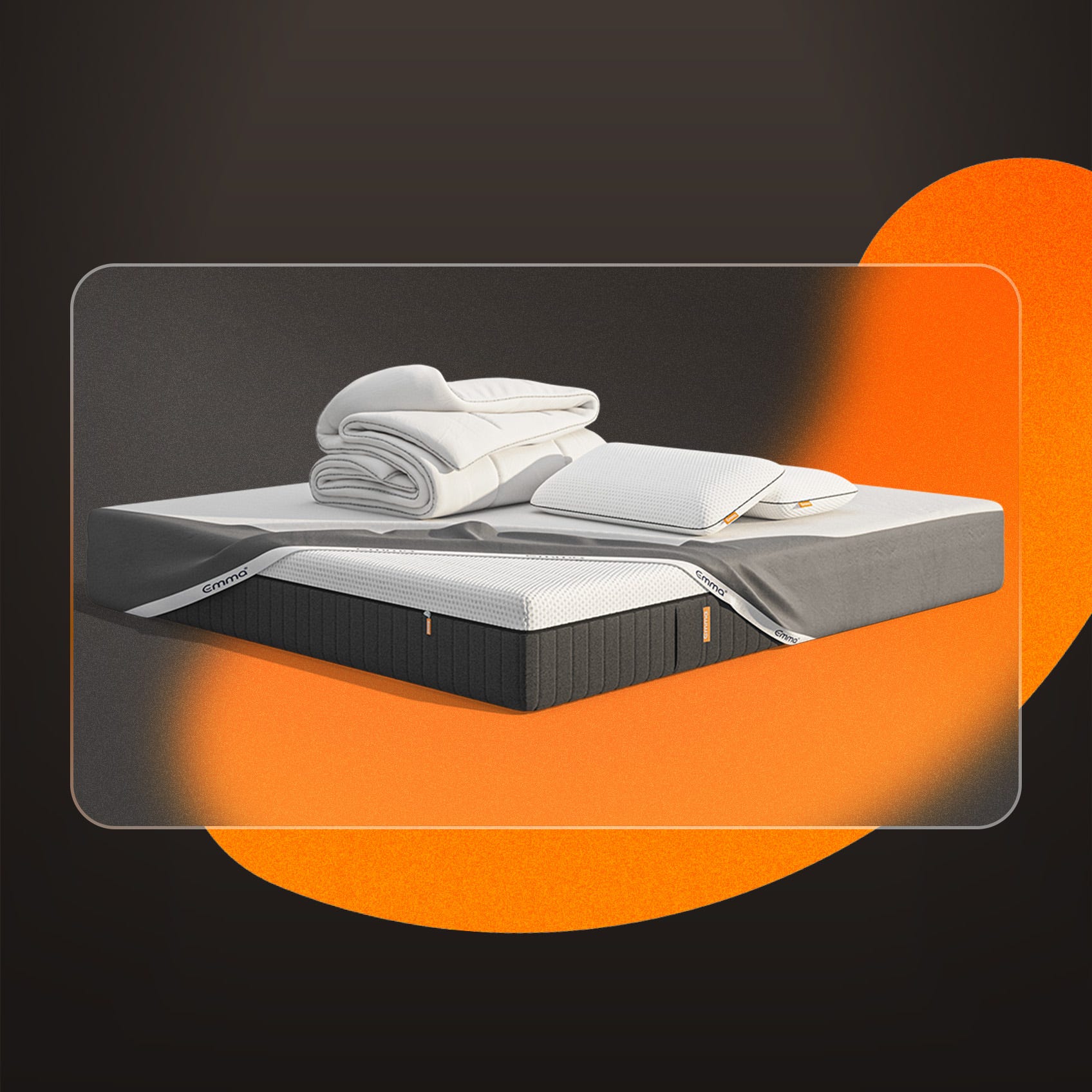 A mattress with a mattress protector, pillows and duvet on a dark background.