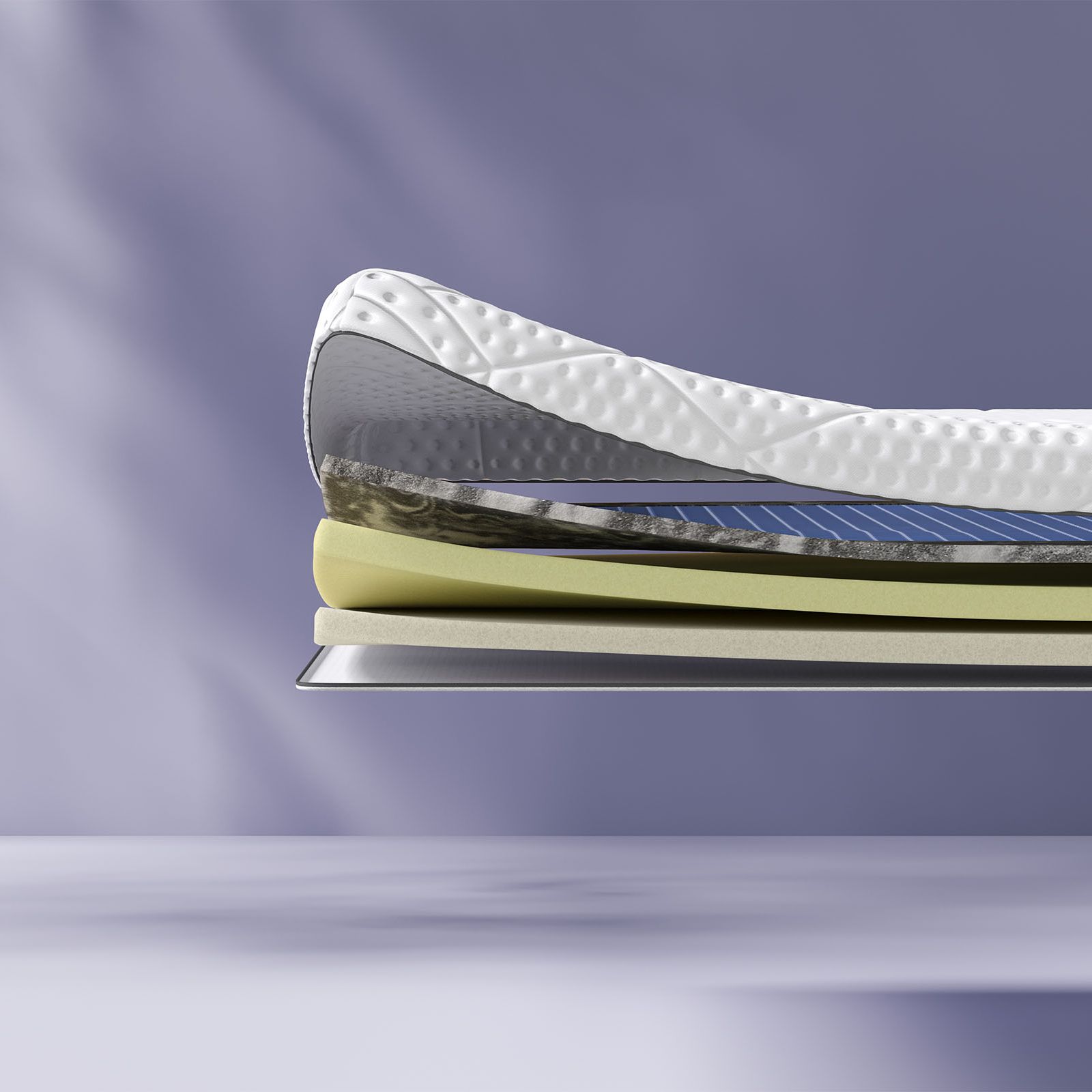 Uma imagem de lado do sobrecolchão Zero Gravity com corte lateral a mostrar as suas camadas, sobre um fundo azul