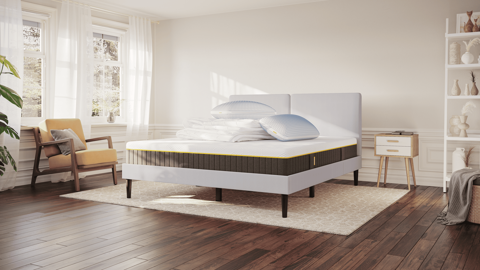 Emma AirGrid Deal Plus: lichtgrijze bed met Emma AirGrid Matras Plus, opgevouwen Emma dekbed (winter/herfst) en twee Emma AirGrid kussens, in een moderne slaapkameropstelling.