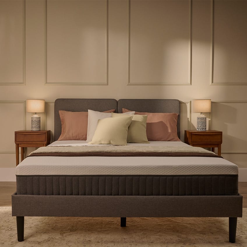 White Emma mattress on an upholstered bed.