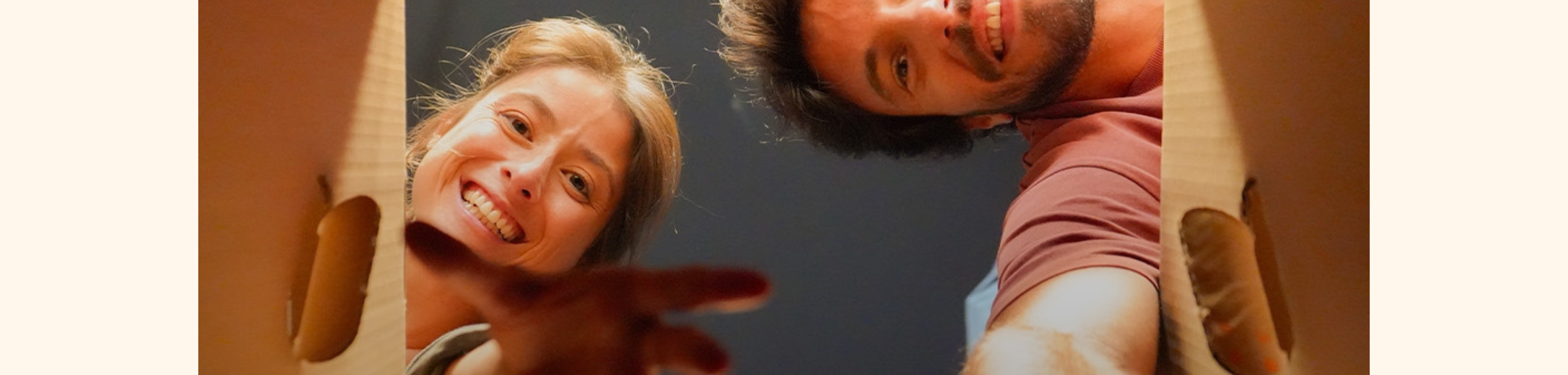 A couple reaching inside an Emma box.