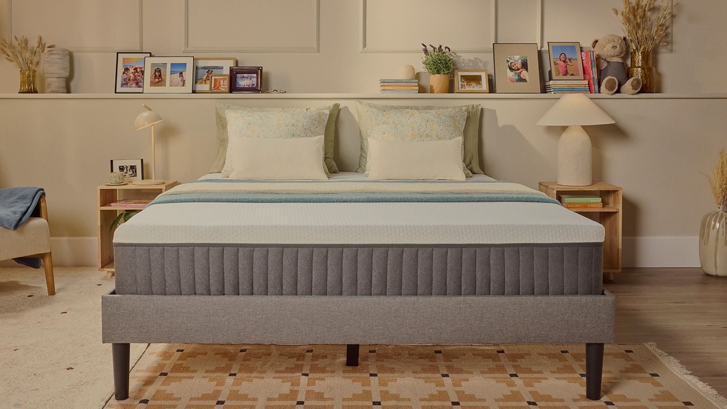 White Emma mattress on an upholstered bed.